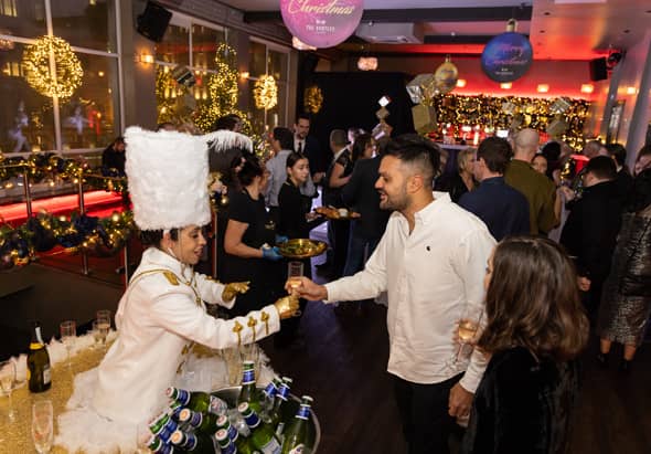 Staff serving food and drinks to guests at a Christmas party at the Bentley Liverpool.